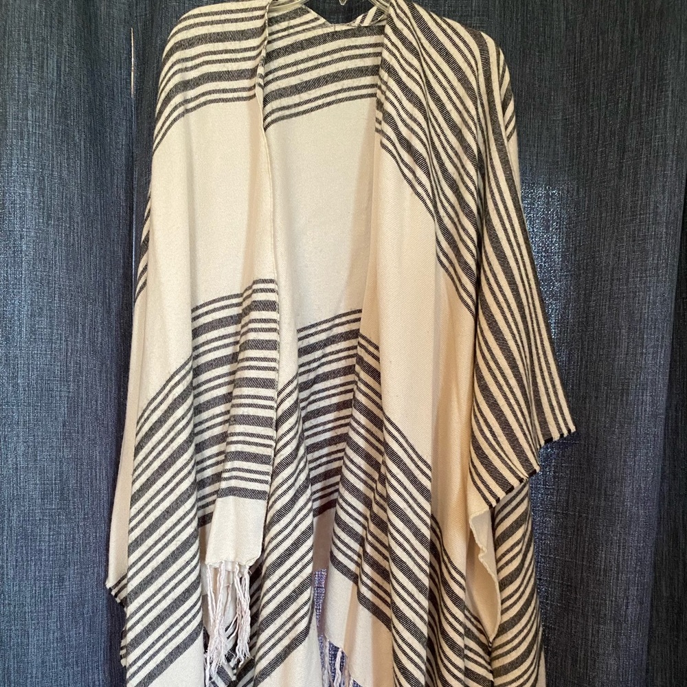 Black and cream poncho with tassels.